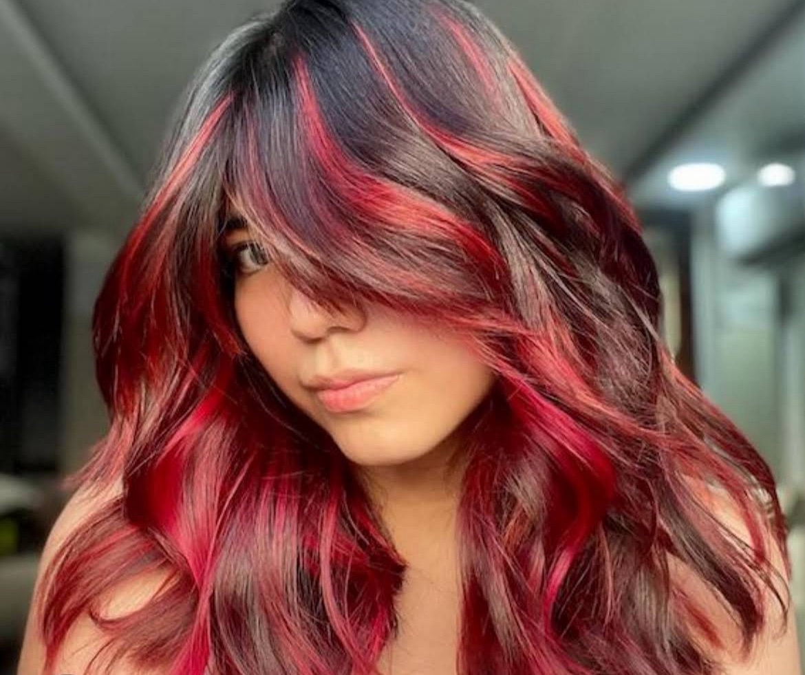 Dimensional red highlights over dark hair